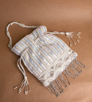 glamorous white potli bag with tassels and pearls#color_white