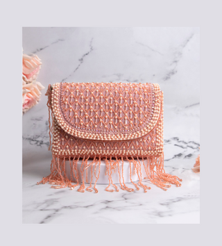 light pink handbag with pearls and tassels#color_light-pink