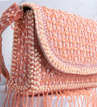 light pink handbag with pearls and tassels#color_light-pink