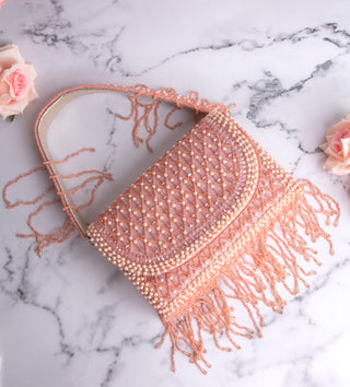 light pink handbag with pearls and tassels#color_light-pink