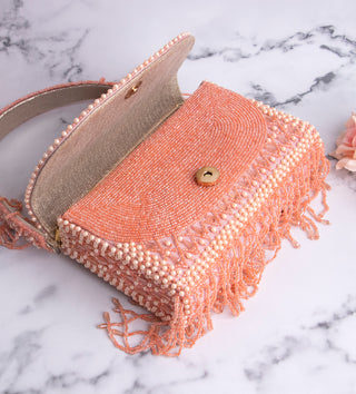 light pink handbag with pearls and tassels#color_light-pink