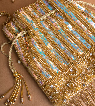 glamorous golden potli bag with tassels and pearls#color_gold
