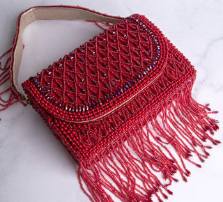 red handbag with pearls and tassels#color_red