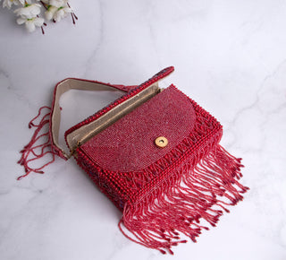 red handbag with pearls and tassels#color_red