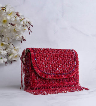 red handbag with pearls and tassels#color_red