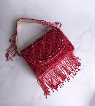 red handbag with pearls and tassels#color_red